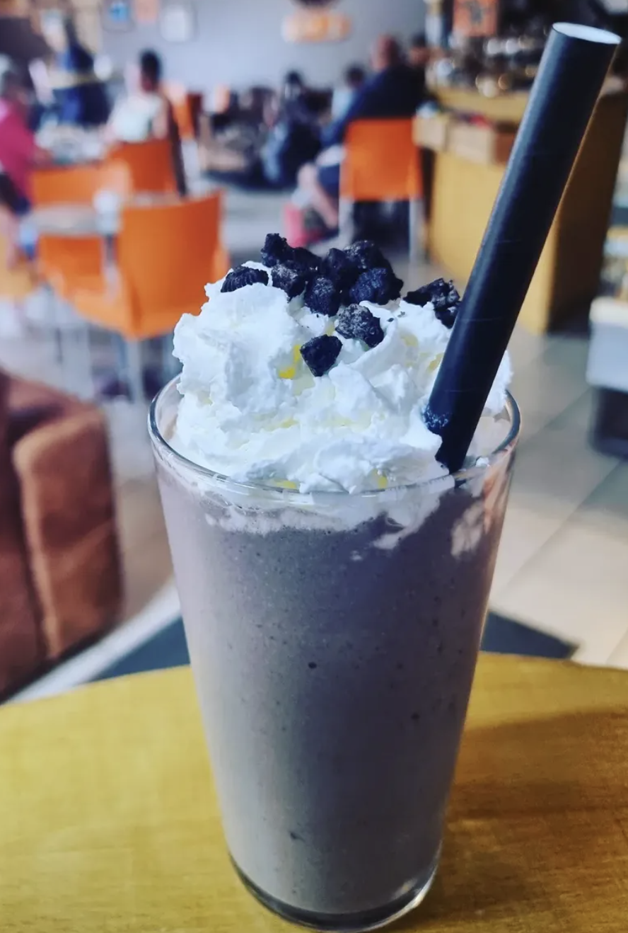 Cookies and cream milkshake topped with whipped cream and Oreo crumbs at Baobab Cafe