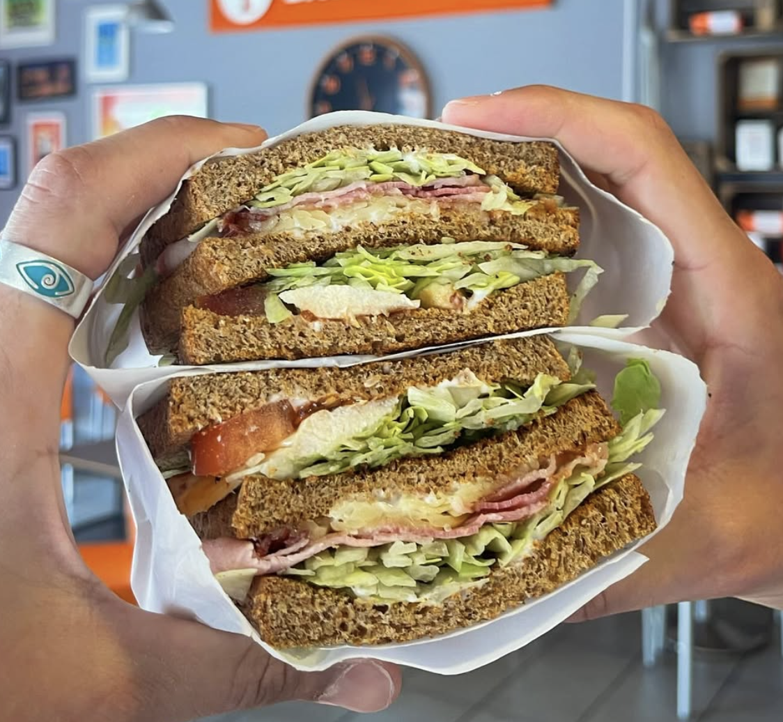 Freshly made club sandwich on seeded bread at Baobab Cafe